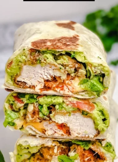 Delicious crispy chicken wrap with fresh vegetables and sauces