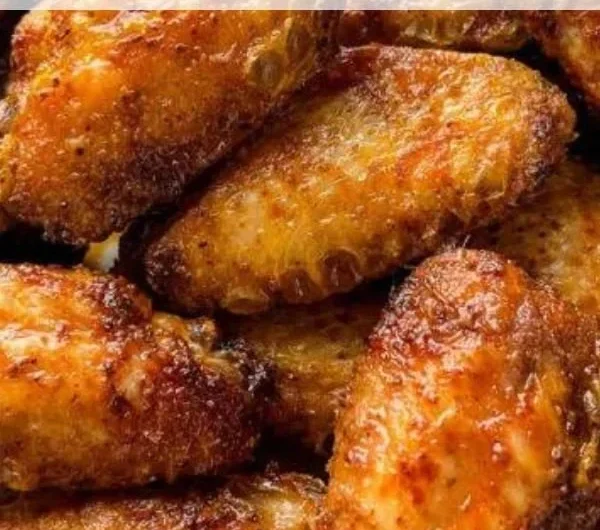 Crispy dry rub chicken wings served in a bowl, garnished with parsley.
