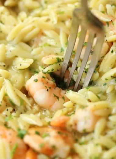 Plate of Garlic Butter Prawn Orzo garnished with herbs