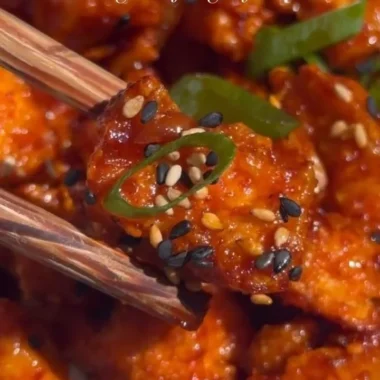 Delicious Gochujang Tofu dish garnished with fresh vegetables and spices.