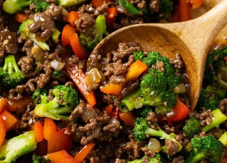 Ground beef and broccoli stir-fry served in a bowl with rice