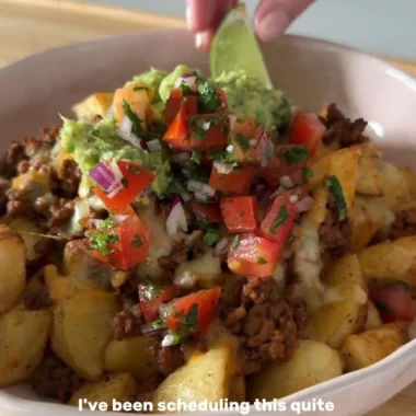 Delicious loaded potato taco bowl featuring crispy potatoes and fresh toppings