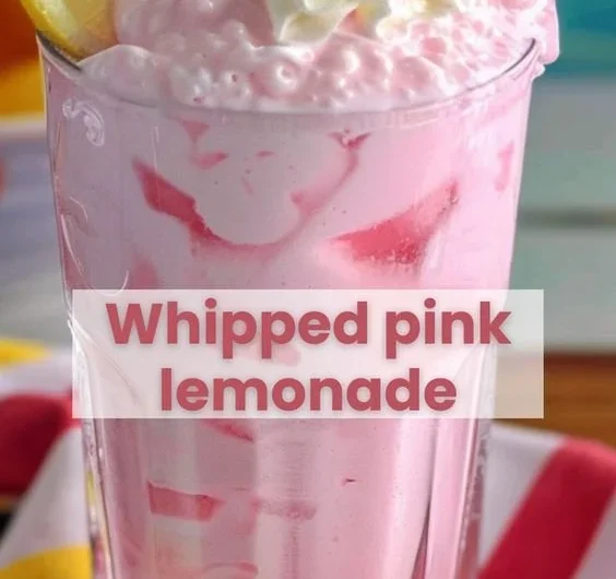Delicious strawberries and cream lemonade served in a glass with fresh strawberries