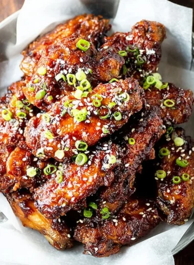 Air Fryer Korean Chicken Wings garnished with sesame seeds and green onions.