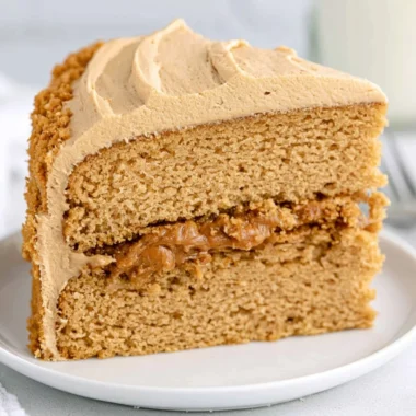 Delicious Biscoff cake topped with creamy frosting and cookie crumbs.