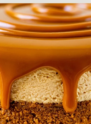 Delicious Biscoff Cheesecake topped with caramel drizzle and cookie crumbles