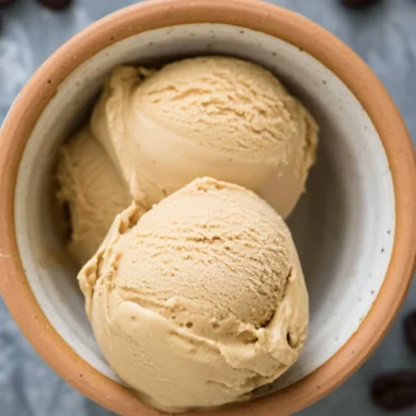 Delicious bowl of coffee ice cream topped with chocolate shavings.