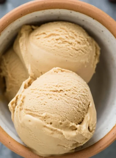 Delicious bowl of coffee ice cream topped with chocolate shavings.