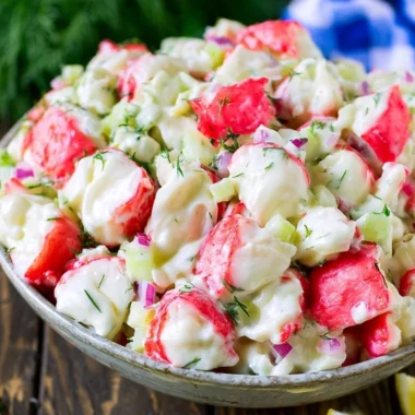 Delicious crab salad garnished with fresh herbs and served in a bowl.
