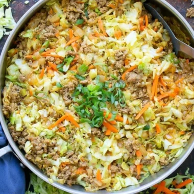 Serving of egg roll in a bowl with colorful vegetables and seasonings