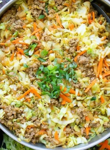 Serving of egg roll in a bowl with colorful vegetables and seasonings