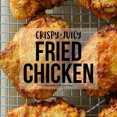 Crispy fried chicken thighs served with dipping sauce and herbs.