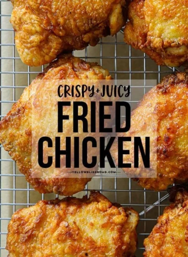 Crispy fried chicken thighs served with dipping sauce and herbs.