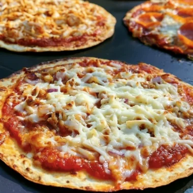 Delicious homemade griddle pizza cooked to perfection on a stovetop griddle.
