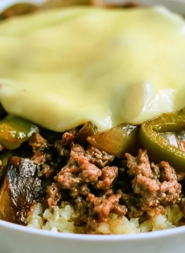 Philly cheesesteak bowl with peppers, onions, and cheese