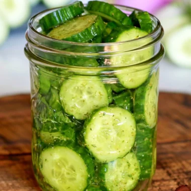 Fresh cucumber snack with herbs and spices on a white plate