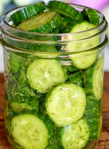 Fresh cucumber snack with herbs and spices on a white plate