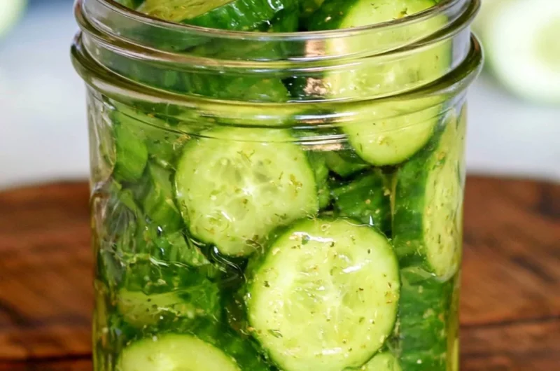 Fresh cucumber snack with herbs and spices on a white plate