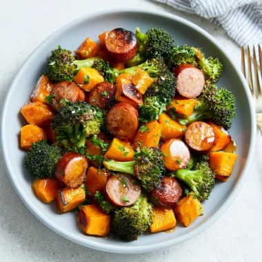 Sheet pan sausage with roasted sweet potatoes on a dining table