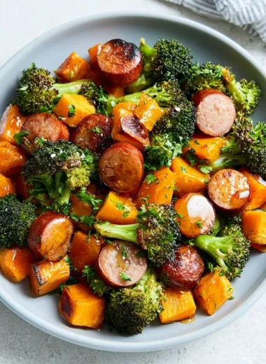 Sheet pan sausage with roasted sweet potatoes on a dining table