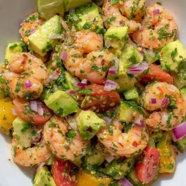 Fresh and colorful shrimp salad recipe featuring shrimp, vegetables, and dressing.