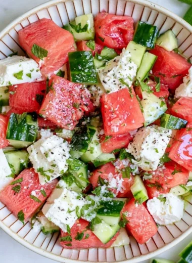 Refreshing watermelon cucumber salad with feta cheese in a bowl.