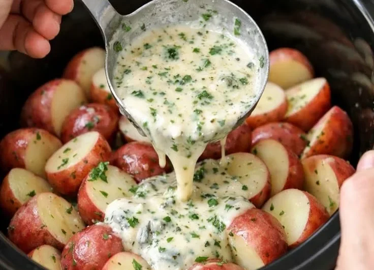 Slow Cooker Herb Ranch Potatoes served in a bowl with fresh herbs