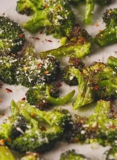 A plate of delicious smashed broccoli with olive oil and spices.