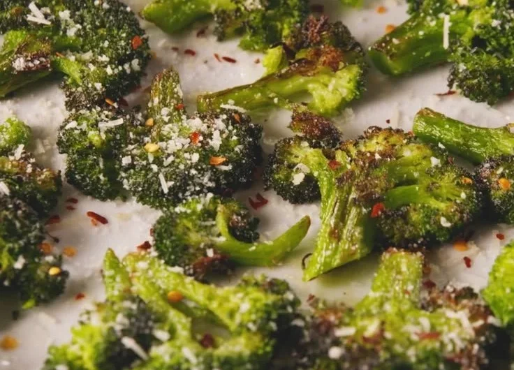 A plate of delicious smashed broccoli with olive oil and spices.