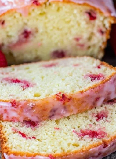 Freshly baked Strawberry Pound Cake topped with strawberries and whipped cream