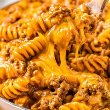 Creamy Enchilada Pasta dish with toppings, perfect for family meals.