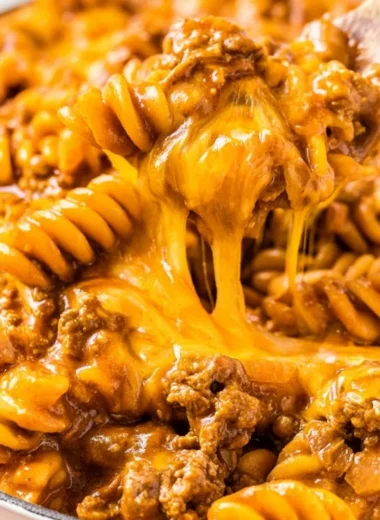 Creamy Enchilada Pasta dish with toppings, perfect for family meals.
