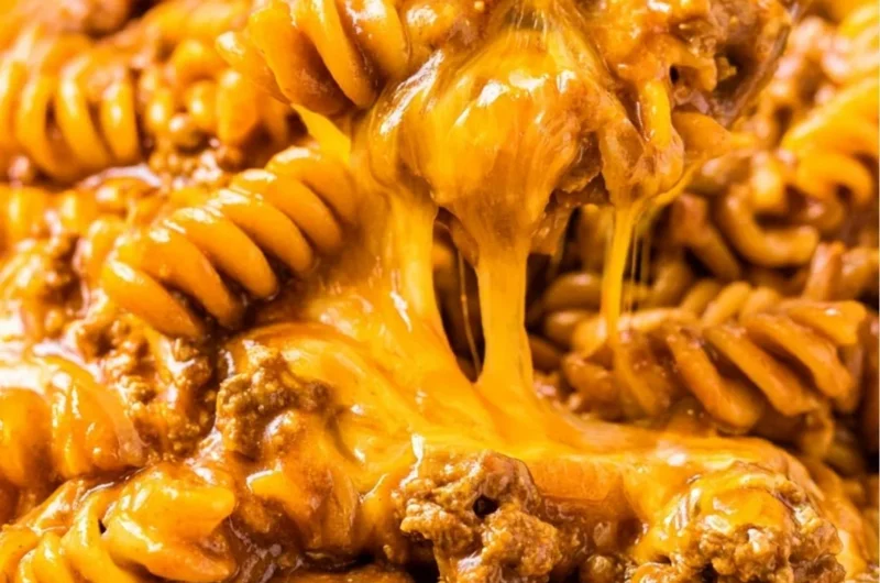 Creamy Enchilada Pasta dish with toppings, perfect for family meals.
