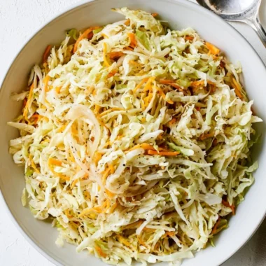Bowl of vibrant vinegar coleslaw with colorful cabbage and carrots