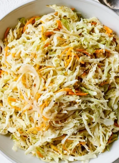 Bowl of vibrant vinegar coleslaw with colorful cabbage and carrots