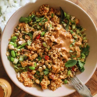 Cozy satay crispy rice salad with vibrant vegetables and aromatic peanut dressing.