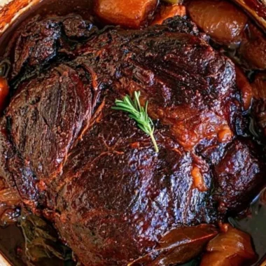 Deliciously cooked beef chuck roast served with vegetables and seasoning.
