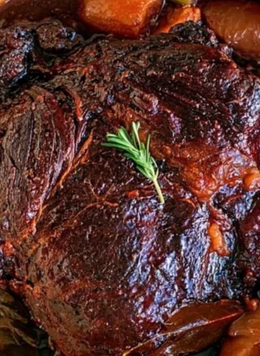 Deliciously cooked beef chuck roast served with vegetables and seasoning.