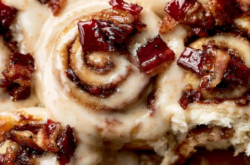 Bourbon Maple Bacon Cinnamon Rolls topped with maple glaze and crispy bacon.