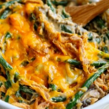 Cozy green bean casserole topped with crispy onions and creamy sauce in a baking dish