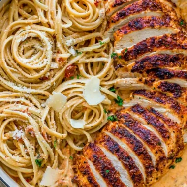 Creamy Cajun Chicken Pasta served in a bowl with fresh herbs and a fork