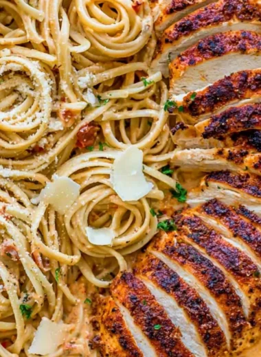 Creamy Cajun Chicken Pasta served in a bowl with fresh herbs and a fork