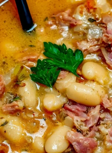 Crock Pot ham bone and bean soup garnished with herbs