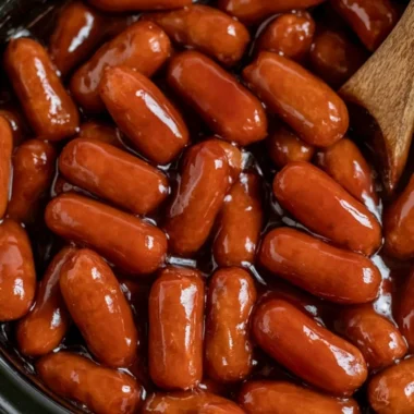 Plate of BBQ Little Smokies made in a Crockpot, garnished with parsley