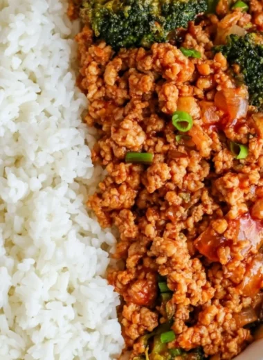 Firecracker ground chicken dish garnished with fresh herbs