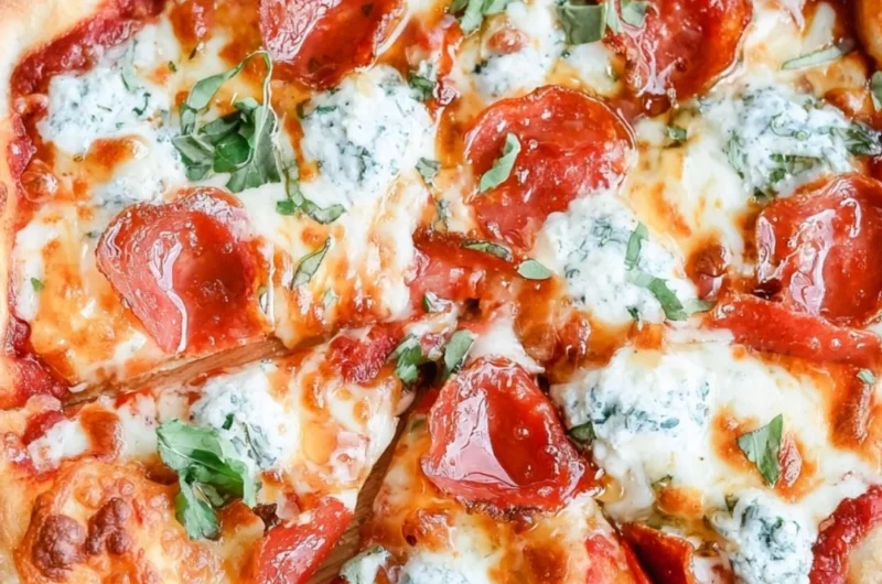 Delicious hot honey pizza topped with cheese and spicy drizzles.