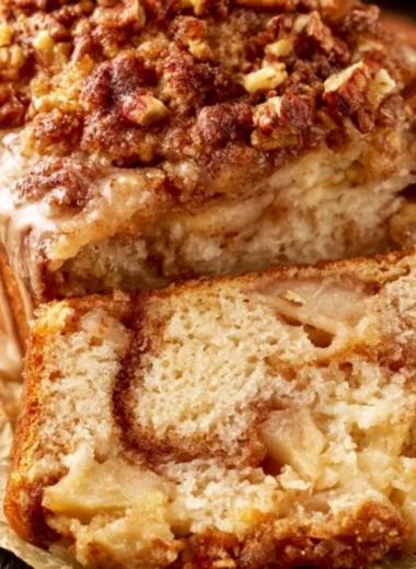 Loaf of moist and tender cinnamon apple bread with a delicious apple topping