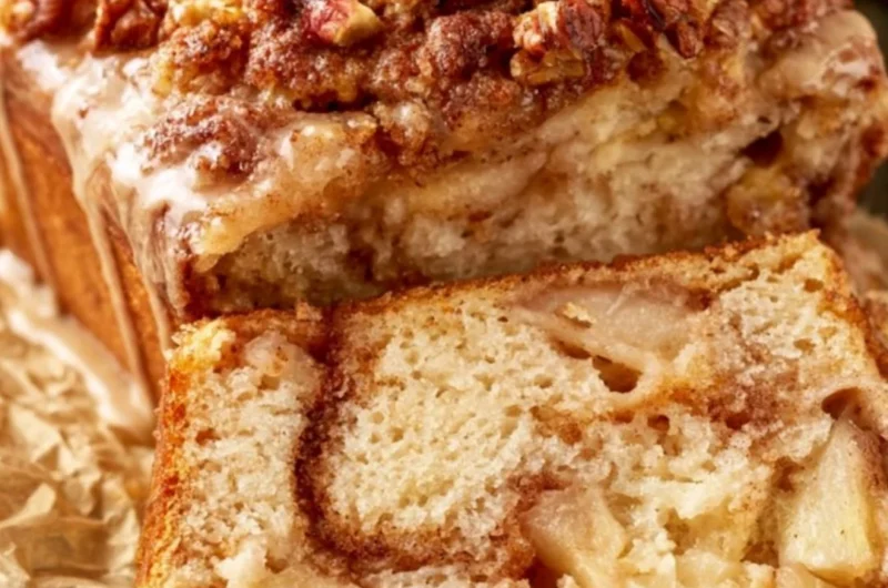 Loaf of moist and tender cinnamon apple bread with a delicious apple topping