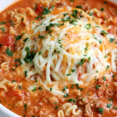 Bowl of quick lasagna soup garnished with basil and cheese