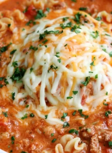Bowl of quick lasagna soup garnished with basil and cheese